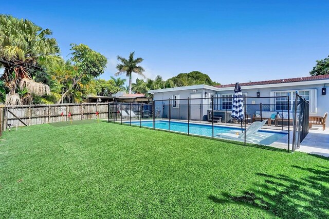 view of yard with a fenced in pool and a patio