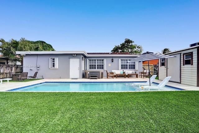 view of swimming pool featuring a lawn and a patio area