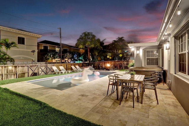 pool at dusk with a patio