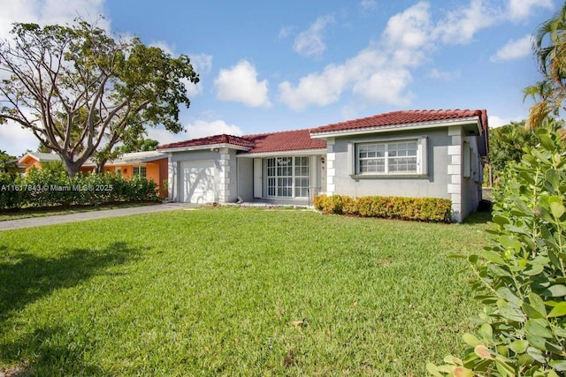 view of front of property featuring a garage and a front lawn