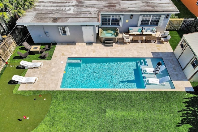 view of pool with outdoor lounge area, a patio, and a yard