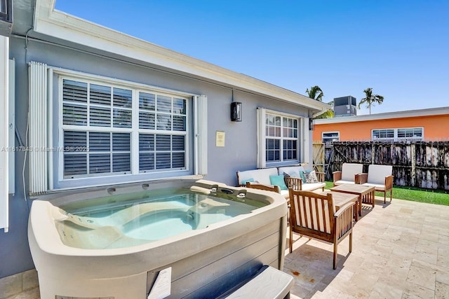 view of patio / terrace featuring a hot tub and outdoor lounge area