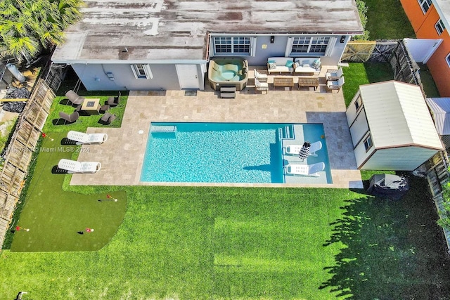 view of swimming pool featuring a patio, an outdoor living space, and a yard