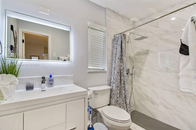 bathroom featuring toilet, vanity, and a shower with shower curtain