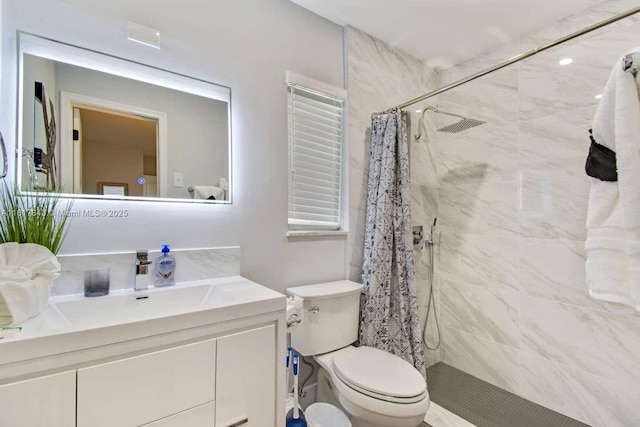 bathroom with vanity, curtained shower, and toilet