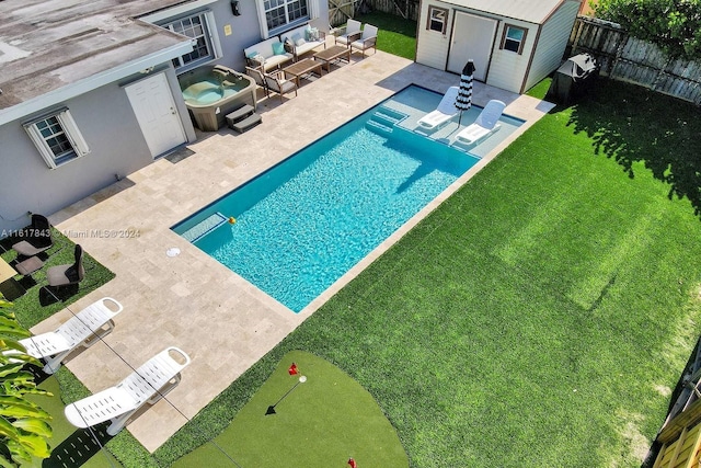 view of pool featuring a patio, an outdoor living space, and a yard