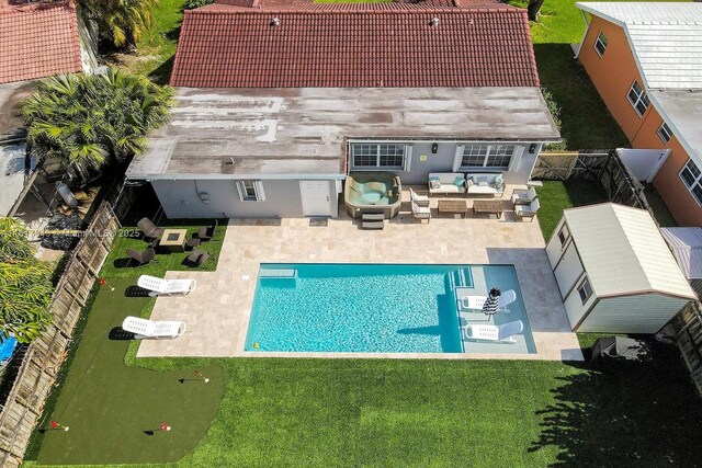 view of swimming pool with an outdoor living space, a patio, and a yard