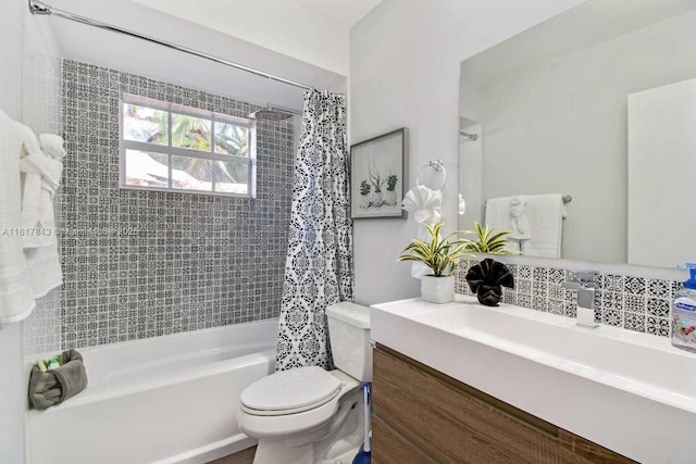 full bathroom featuring vanity, toilet, shower / bath combo with shower curtain, and backsplash