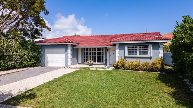 ranch-style house featuring a garage and a front yard