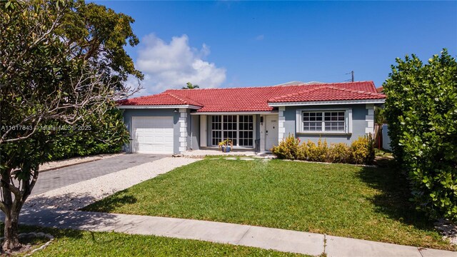 ranch-style house with a garage and a front lawn