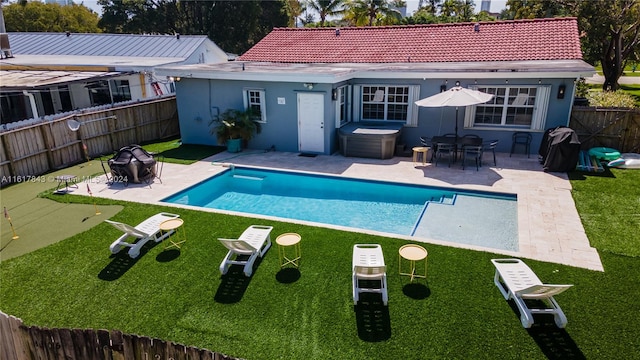 view of pool featuring a patio area and a yard