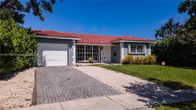 view of front facade with a garage and a front lawn