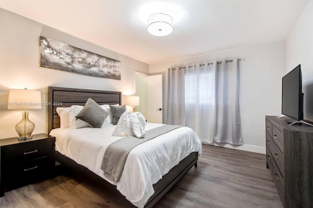 bedroom with hardwood / wood-style flooring