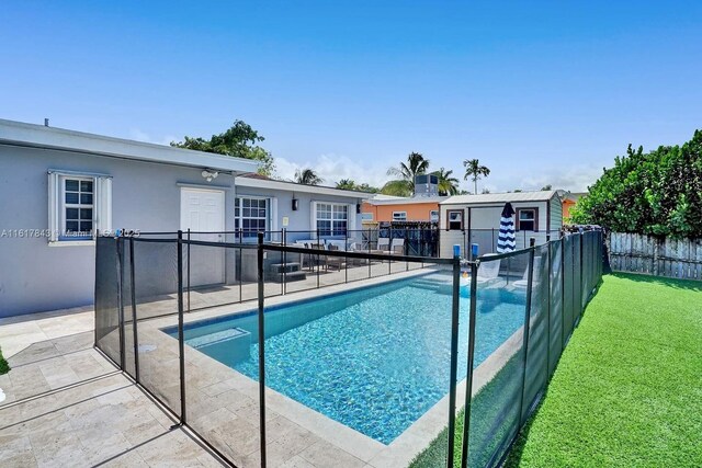 view of pool with an outdoor structure and a patio area