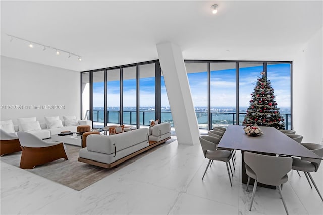 living room featuring a water view and expansive windows