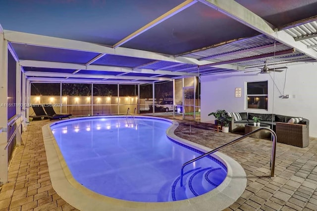 view of pool with a patio area, outdoor lounge area, ceiling fan, and a lanai