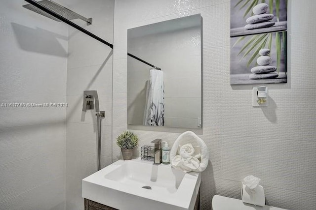 bathroom featuring toilet, tile walls, a shower with shower curtain, and vanity