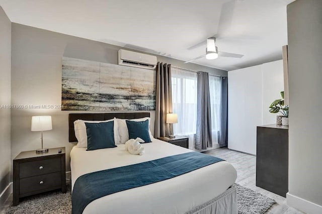 bedroom with ceiling fan and a wall unit AC