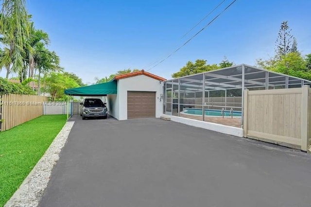 garage featuring a lawn and a fenced in pool