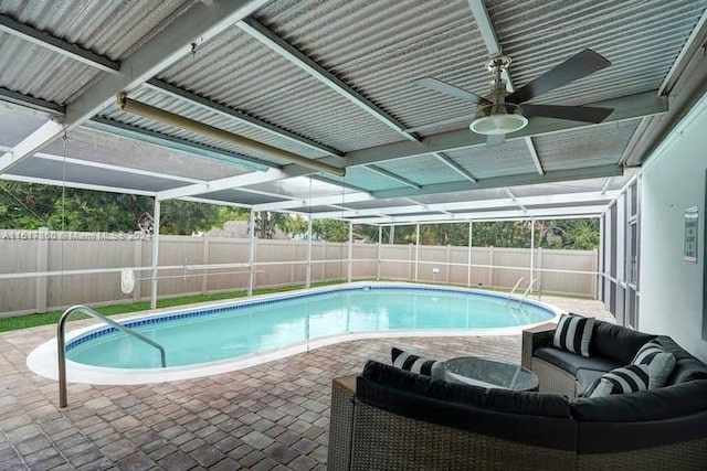 view of pool featuring a patio area, an outdoor living space, ceiling fan, and glass enclosure