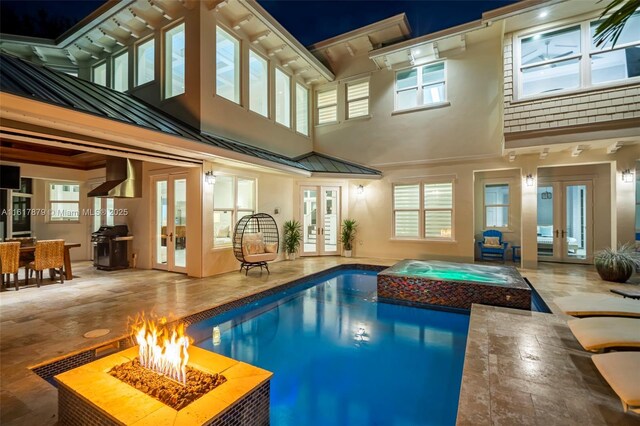 view of pool with grilling area and french doors