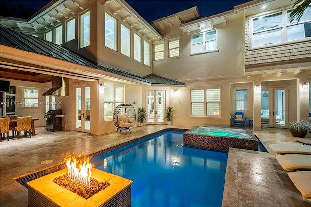 view of pool featuring french doors and a grill