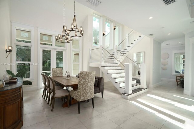 dining space featuring a notable chandelier, a wealth of natural light, and light tile patterned floors