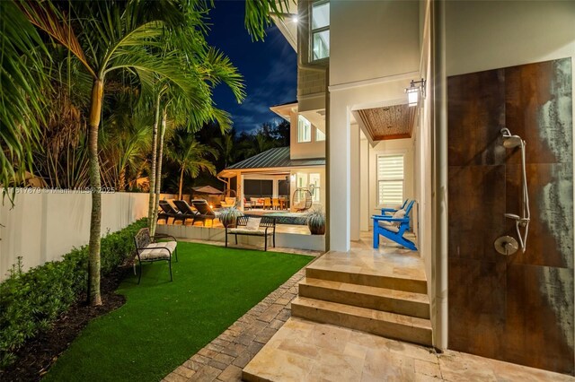 yard at night with a patio