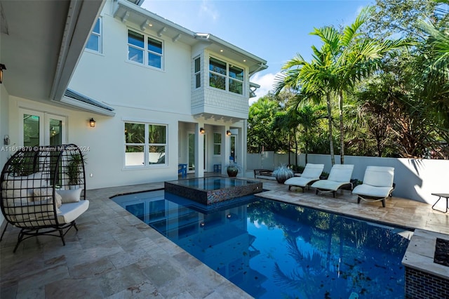 view of pool featuring an in ground hot tub and a patio