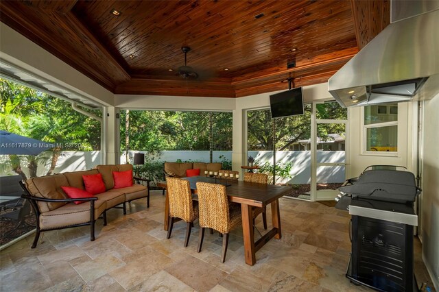 sunroom / solarium featuring wooden ceiling and a tray ceiling