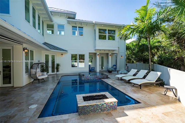 view of swimming pool with a patio area and a fire pit