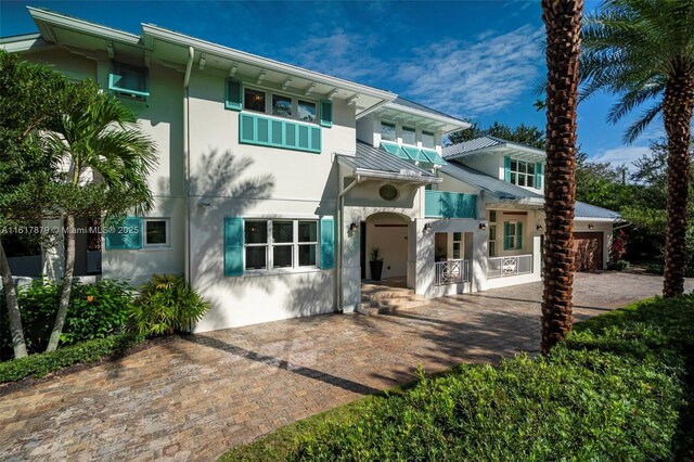 back of property with a patio and a garage