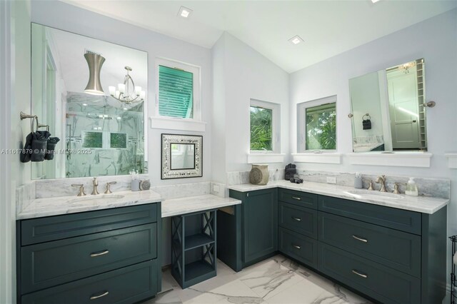 bathroom with tile patterned flooring, vaulted ceiling, vanity, and an inviting chandelier