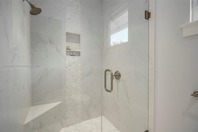 bathroom with walk in shower and toilet