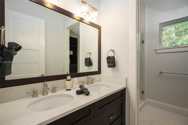 bathroom with tile patterned floors, a shower with door, and double vanity