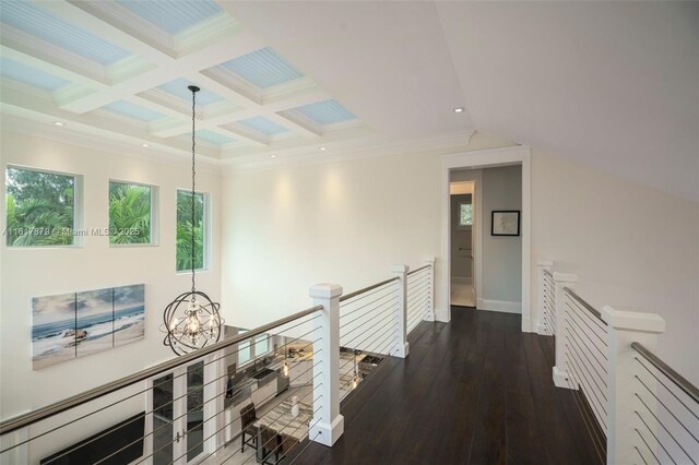 hall featuring a chandelier, ornamental molding, beam ceiling, coffered ceiling, and dark wood-type flooring