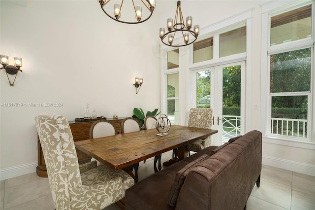 dining room featuring french doors, light tile patterned floors, and an inviting chandelier