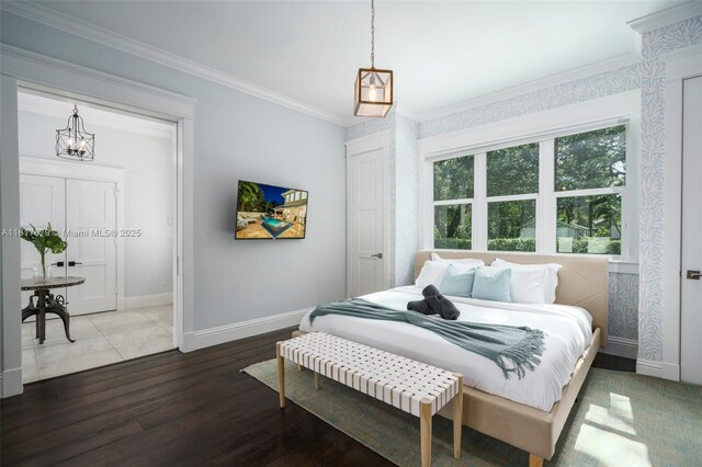 bedroom with ornamental molding and hardwood / wood-style floors