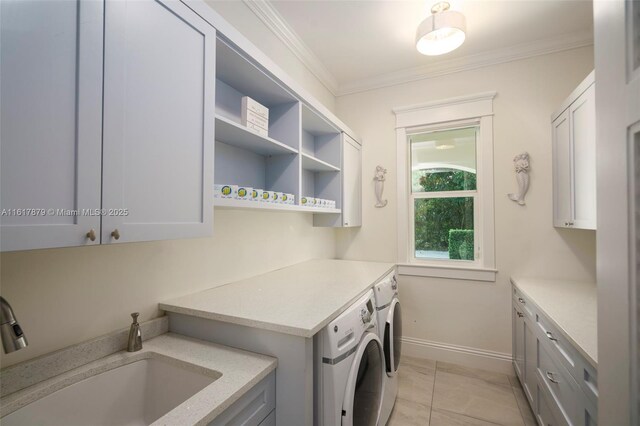 laundry room with crown molding, light tile patterned floors, independent washer and dryer, cabinets, and sink