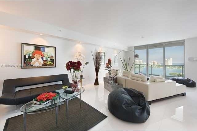 living room featuring floor to ceiling windows