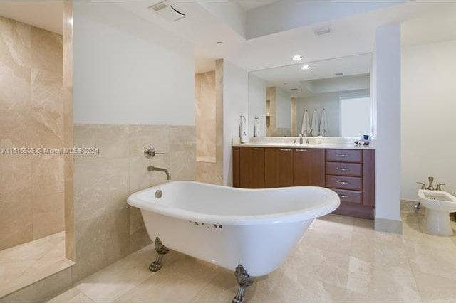 bathroom featuring vanity, a bidet, tile walls, and tile patterned flooring