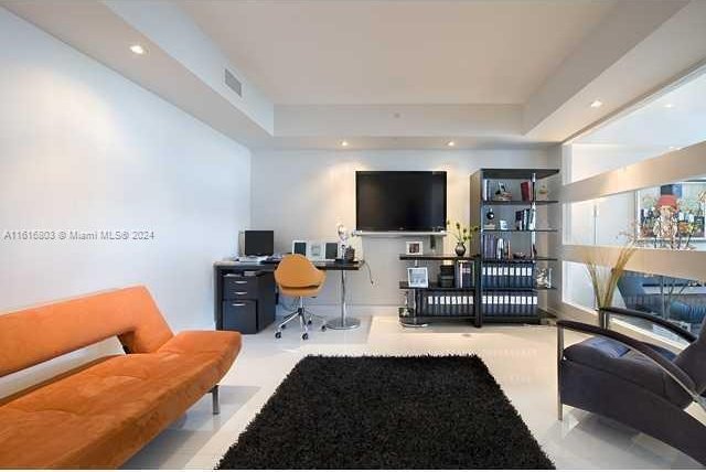 living room featuring a tray ceiling