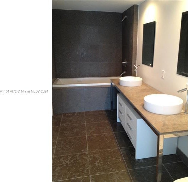 465 Brickell Ave Unit 3706, Miami, FL 33131 - bathroom with tile patterned flooring, tiled tub, and double vanity