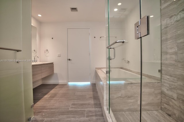 bathroom with vanity and a shower with shower door