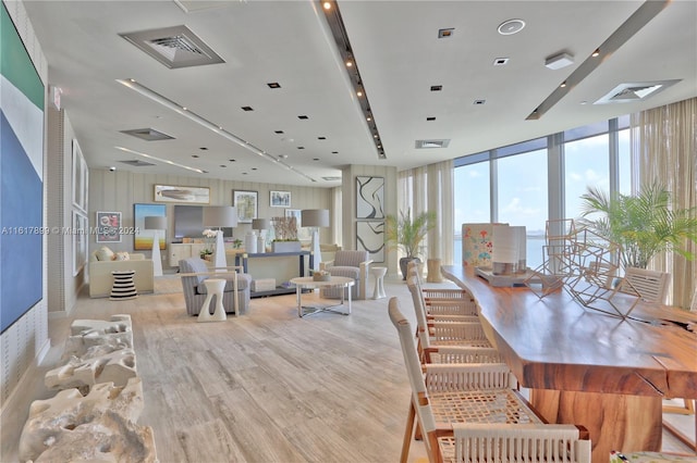 living room featuring light hardwood / wood-style floors and a wall of windows