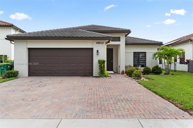 view of front of home featuring a garage and a front lawn