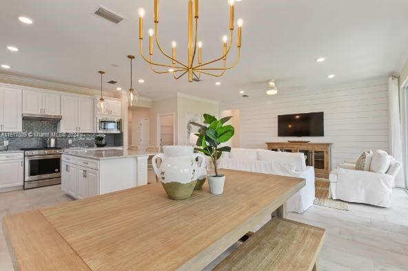 dining room featuring a notable chandelier and crown molding