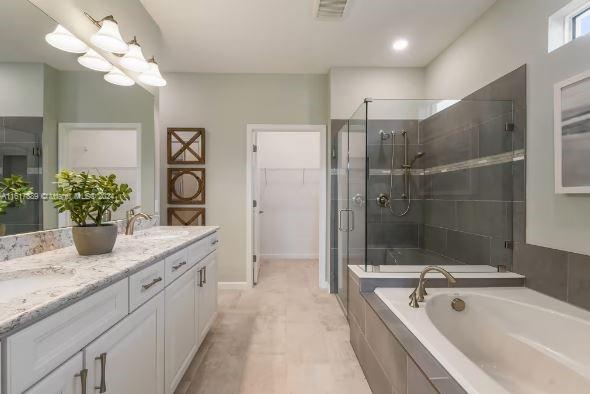 bathroom featuring shower with separate bathtub, tile patterned flooring, and dual bowl vanity