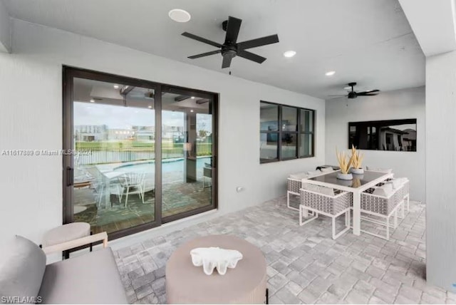 tiled dining space with ceiling fan