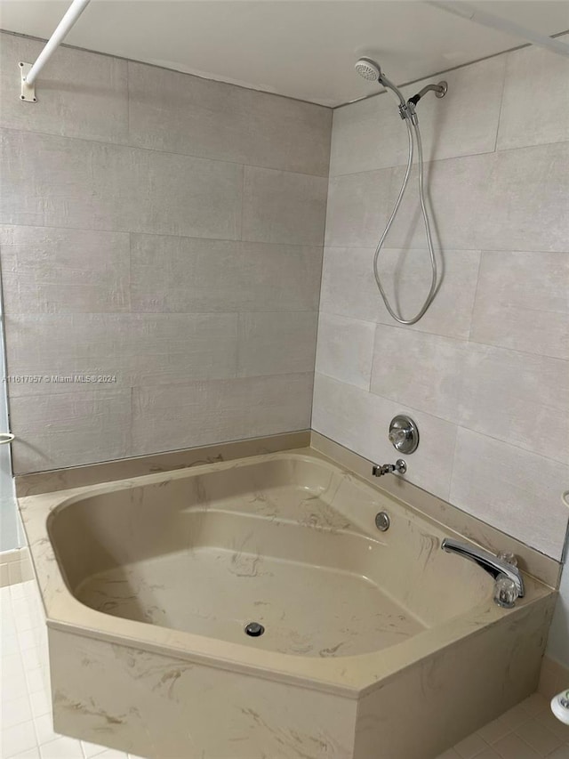 bathroom featuring tiled shower / bath combo and tile patterned floors